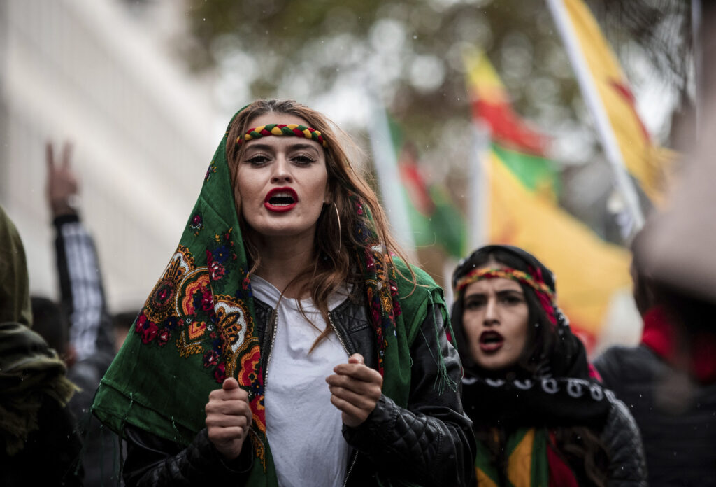 Participants of a Kurdish demonstration against the Turkish military offensive in Northern Syria demonstrate in Cologne, Germant, Saturday, Oct.19, 2019.  (Fabian Strauch/dpa via AP)